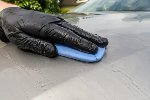 Clay treatment removing contamination from car paint